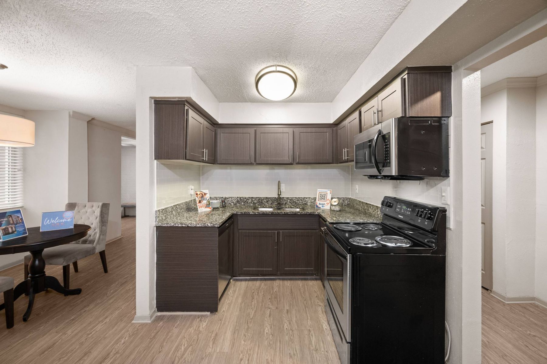 Luxury apartment kitchen with stainless steel appliances, granite countertops, and lots of storage space